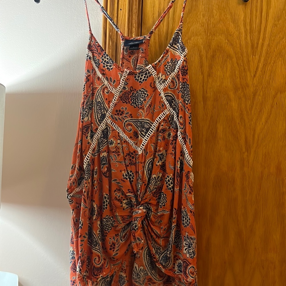 Burnt orange tank top with adjustable straps, cream and blue design